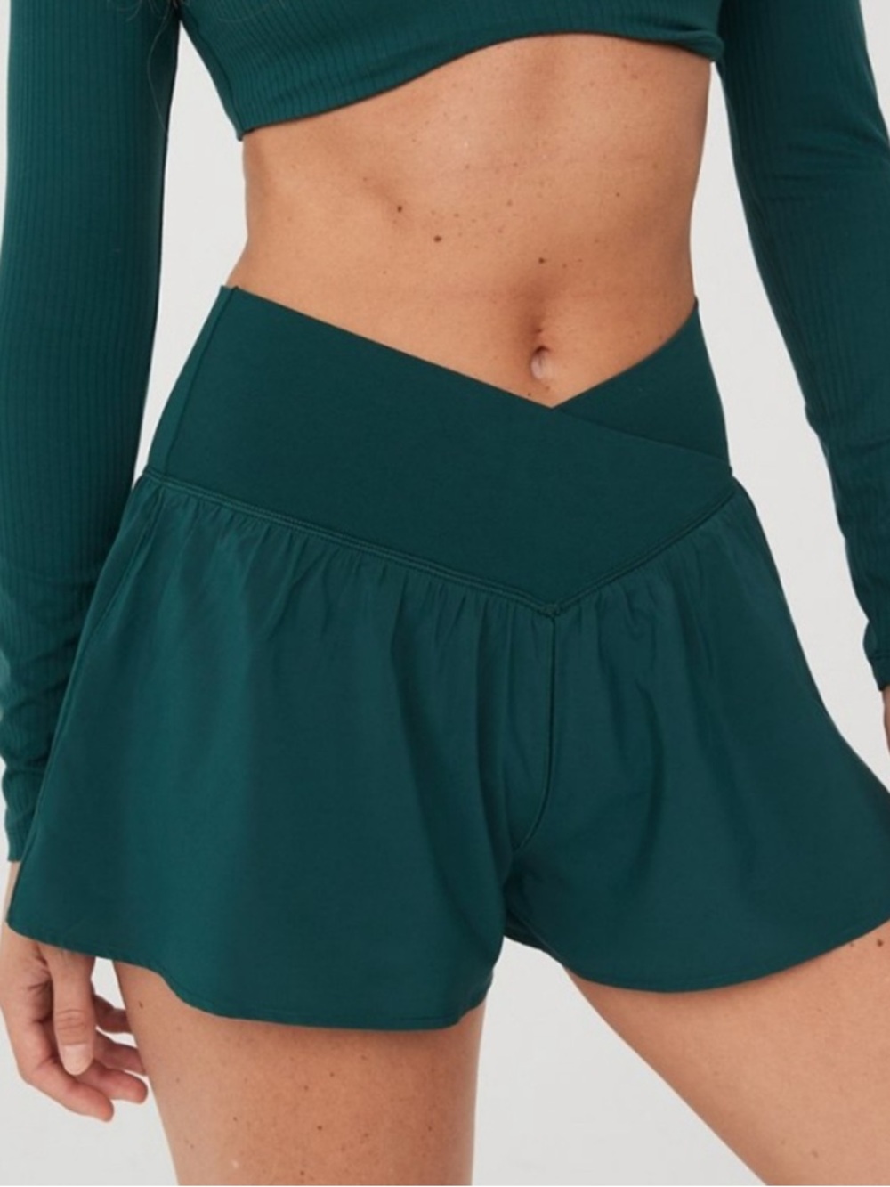 aerie offline real me crossover flowy shorts in a dark teal green color